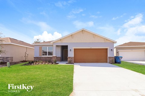 A house with a garage door is for sale by FirstKey Homes.