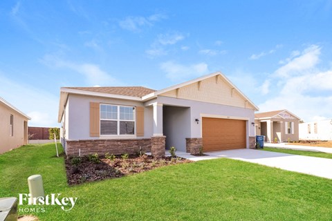 A house with a garage and a driveway is shown in the image.