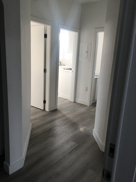 a view of the hallway from the living room into the bedroom and the bathroom