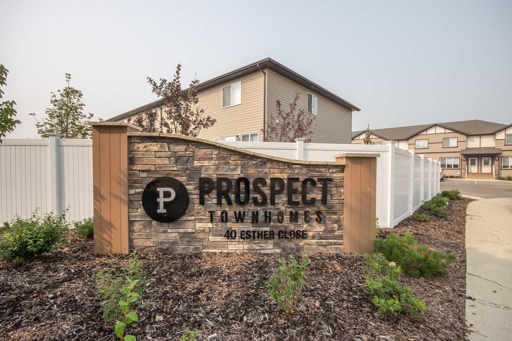 A sign for Prospect Tow Homes with a parking symbol on it.