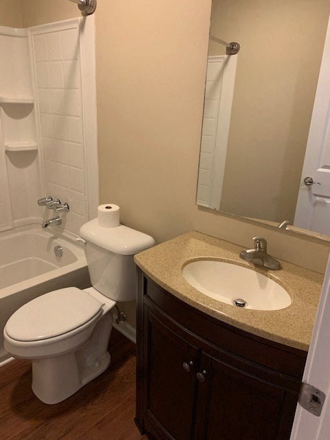 A white toilet sits next to a sink in a bathroom.