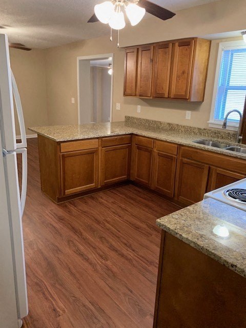 A kitchen with wooden cabinets and a granite countertop.