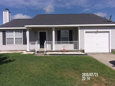 a white house with a lawn in front of it