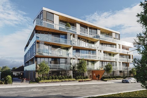 A modern multi-story residential building with balconies and glass windows.