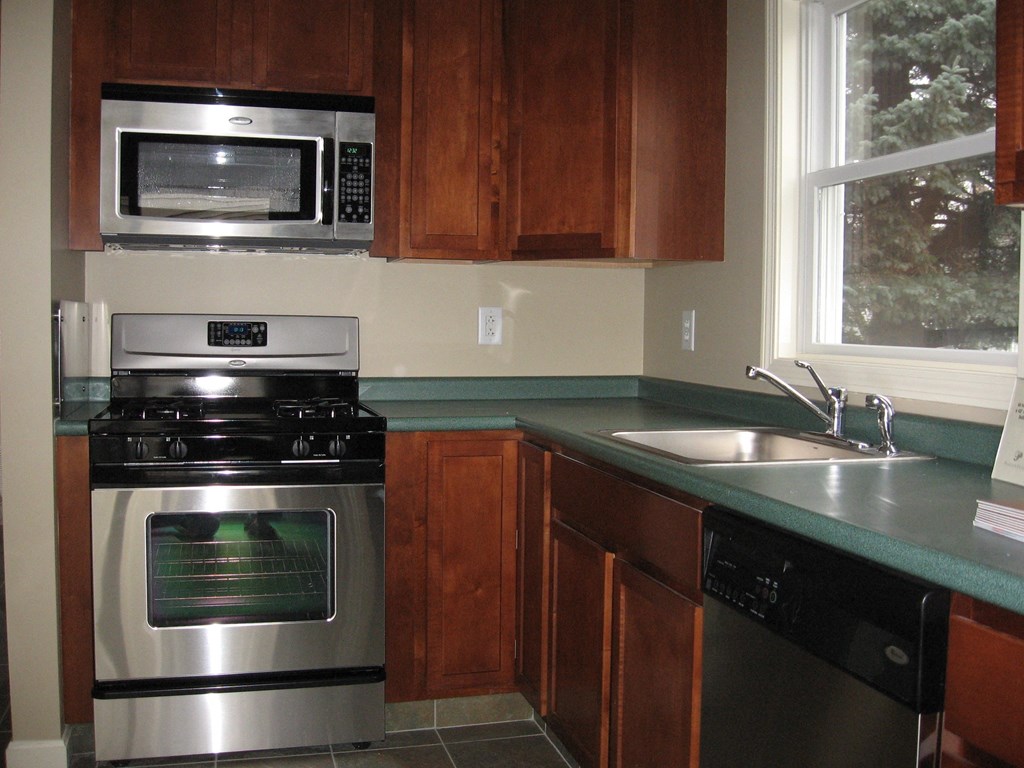 a kitchen with a stove and a sink and a microwave