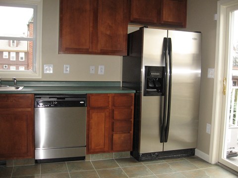 a kitchen with stainless steel appliances and wooden cabinets