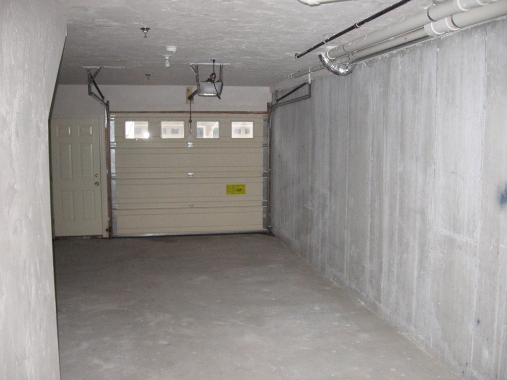 an empty garage with a white garage door
