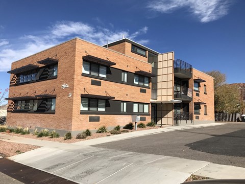 a brick building with a blue sky in the background
