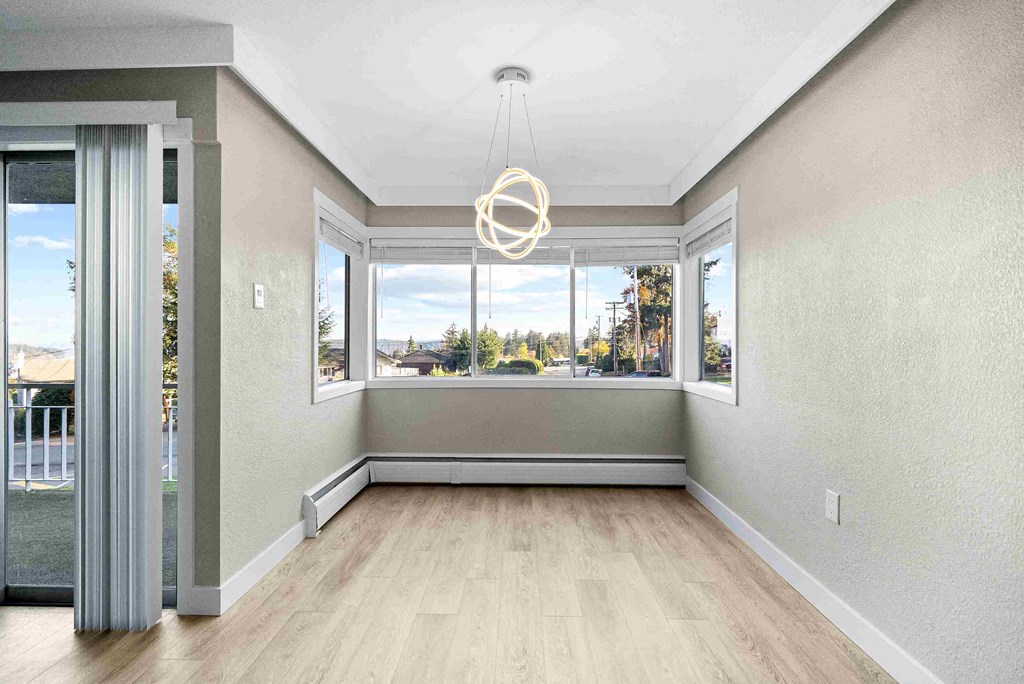 an empty living room with a large window