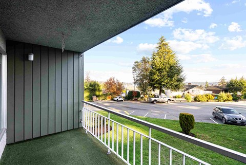 a view of the street from the balcony of a house
