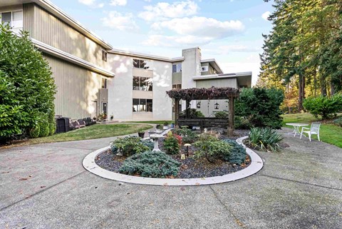 a courtyard with a fountain in front of a house