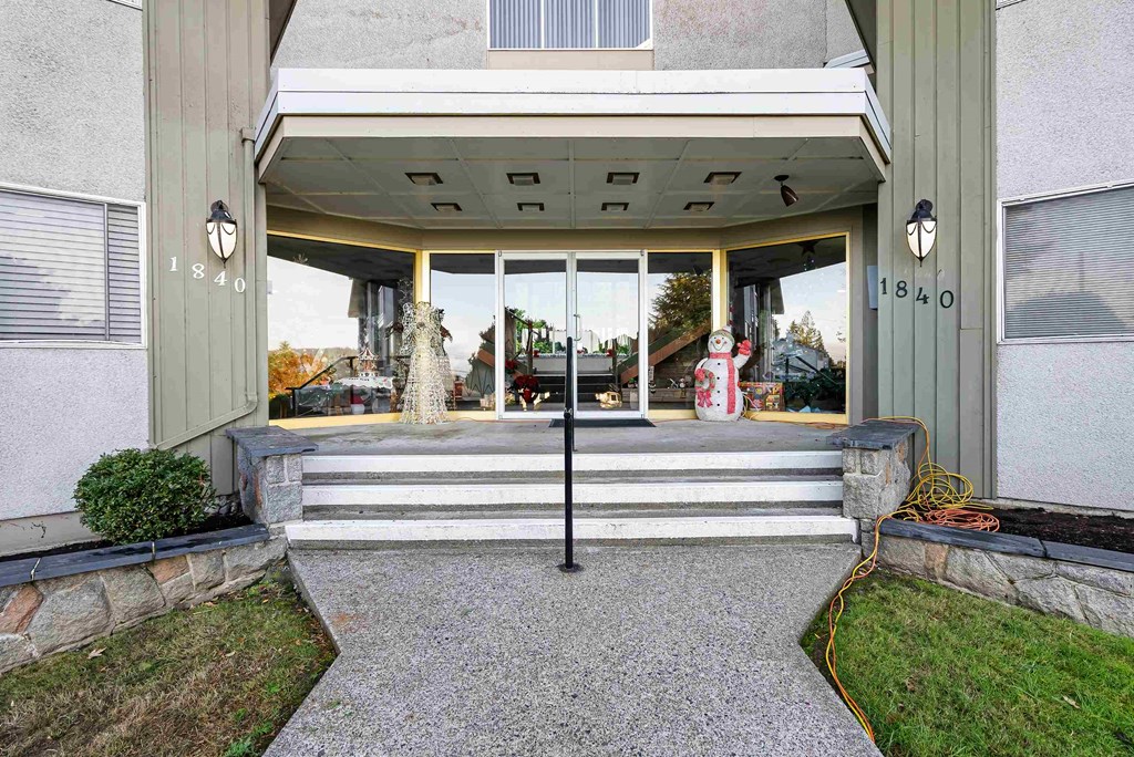 the front entrance of a home with a large glass door and stairs