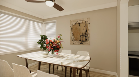 A dining room with a table, chairs, and a painting on the wall.