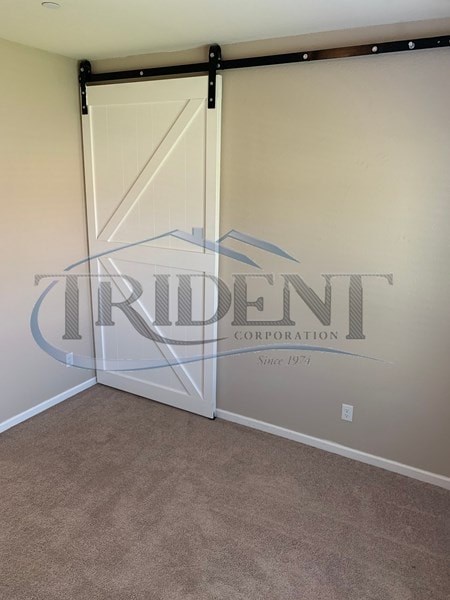 A room with a sliding door and a logo of Trident Corporation on the wall.