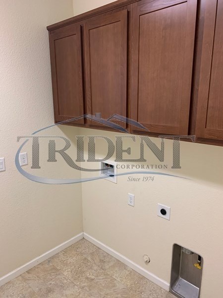 A wall with a company logo and the name "Trident Corporation" on it.