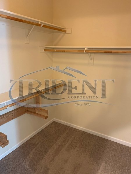 A room with a logo that says "Trident Corporation" on the wall.