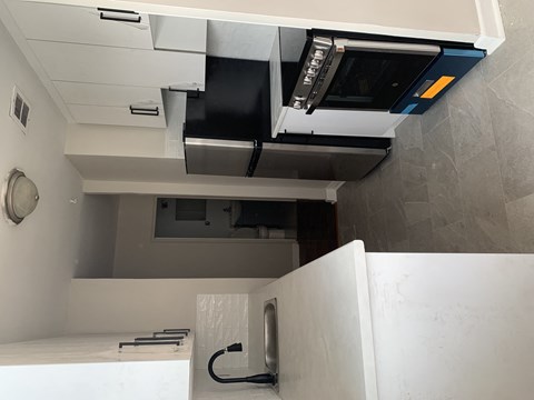 an overhead view of a kitchen with a stove and a microwave