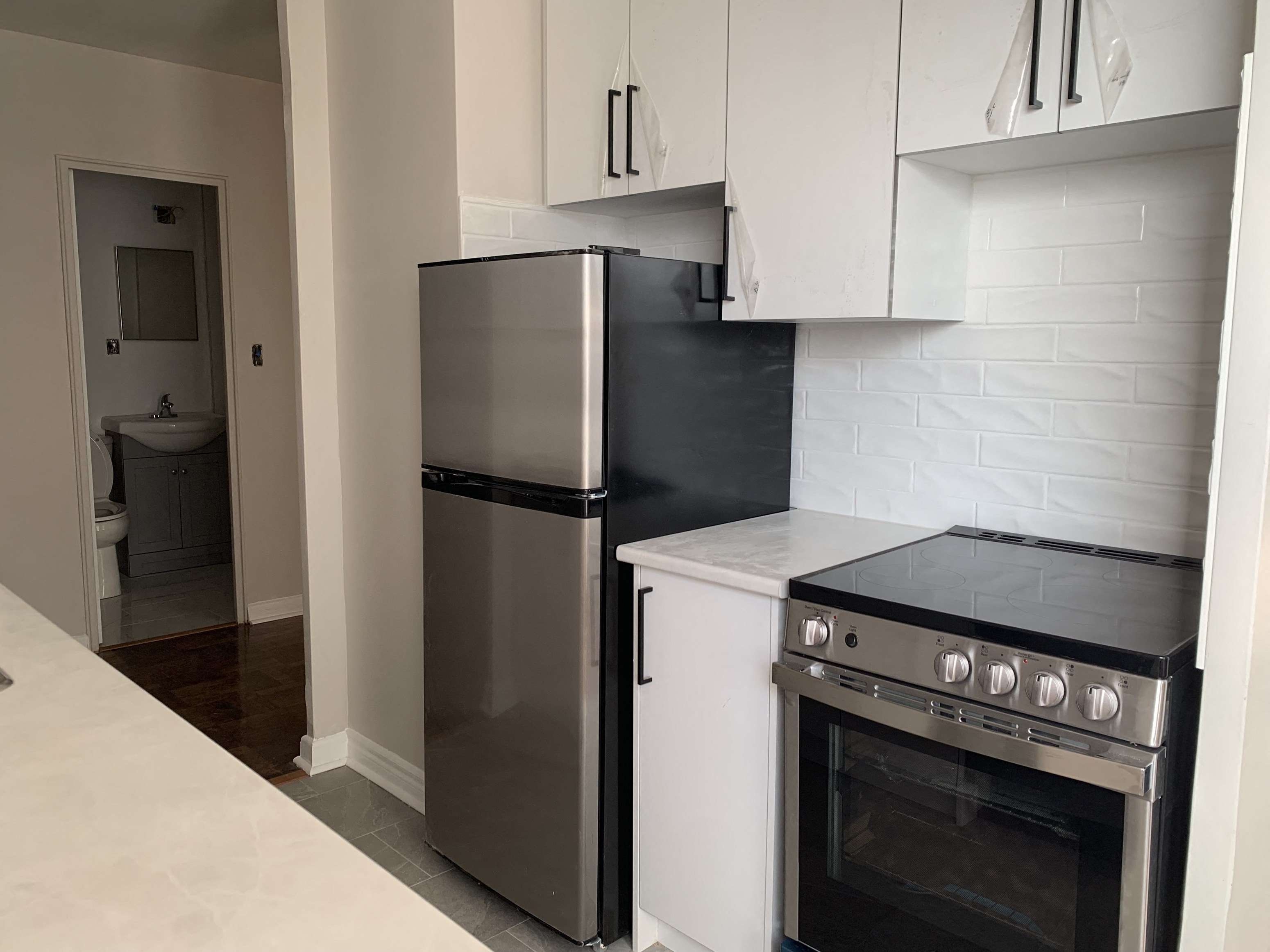 a kitchen with a stove and a refrigerator