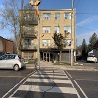 a car driving down a street in front of a building