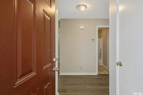 a hallway with a door open to a bedroom