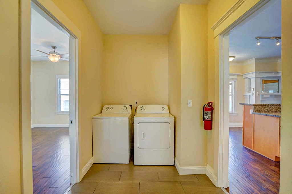 a laundry room with two washer and dryers in it