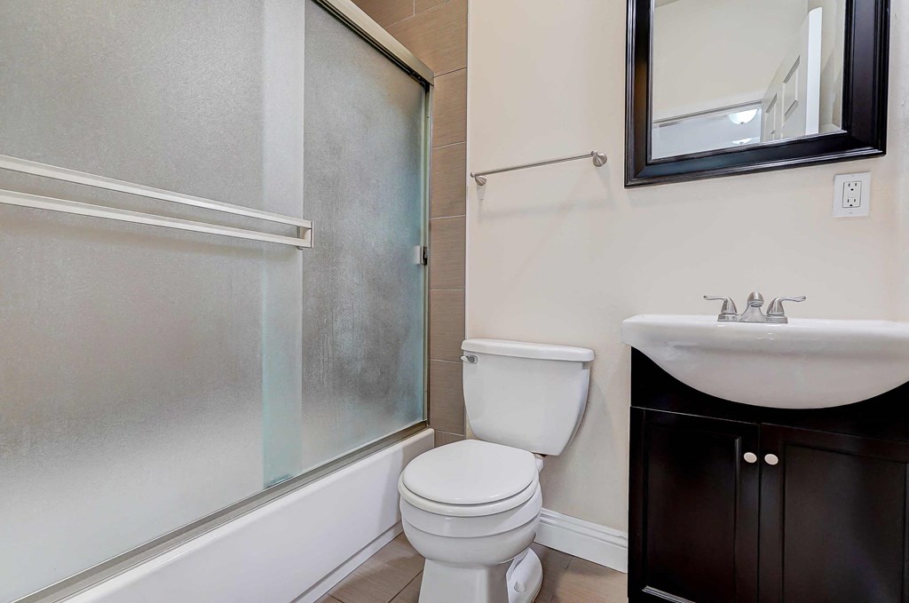 a bathroom with a toilet and a sink and a shower