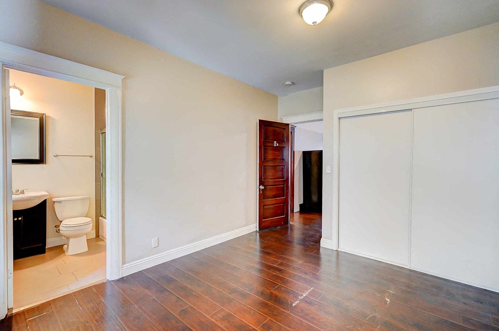 a living room with a door to a bathroom and a toilet
