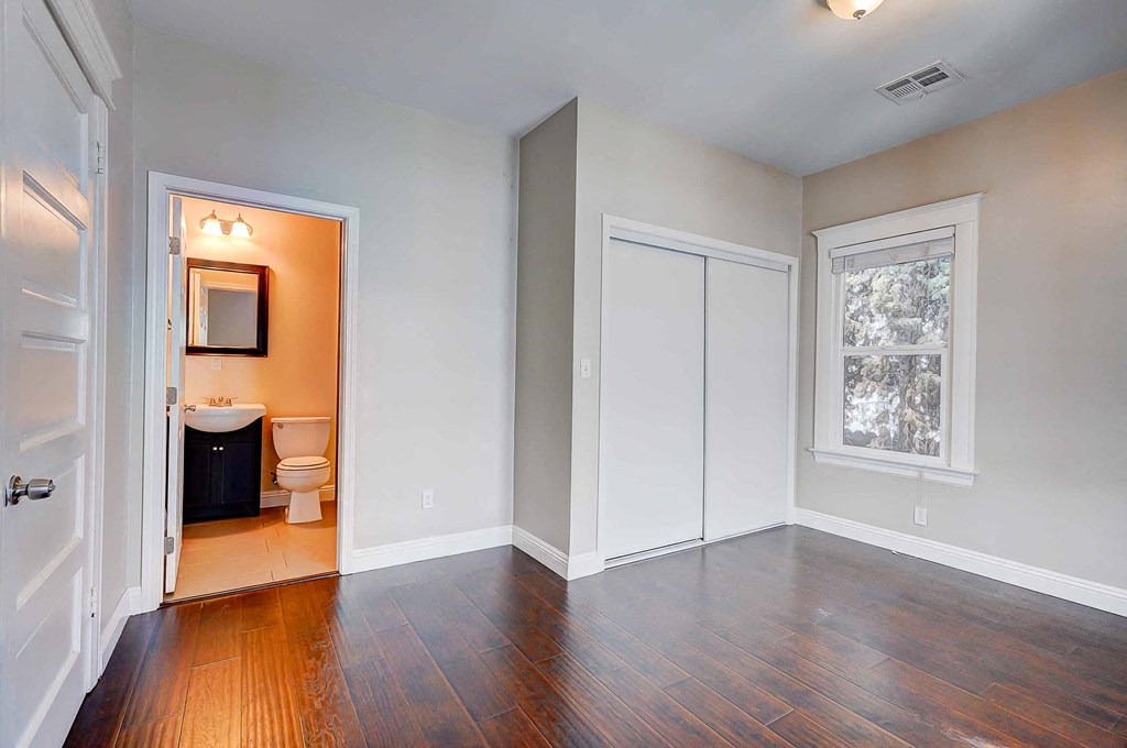 an empty living room with a toilet and a window