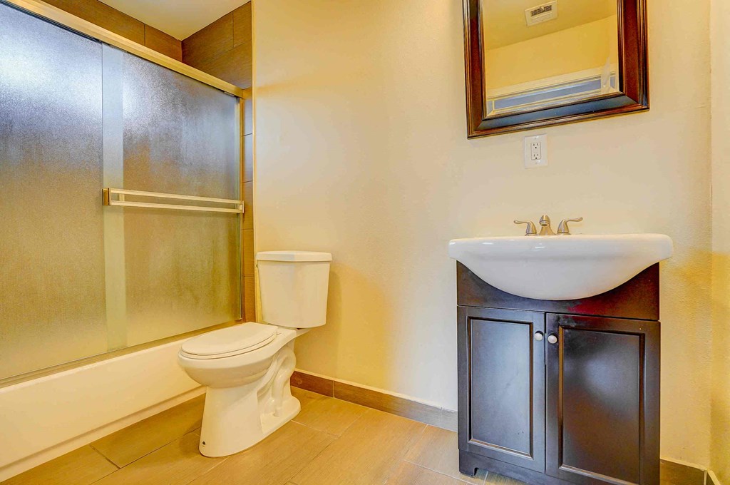 a bathroom with a sink and a toilet and a shower