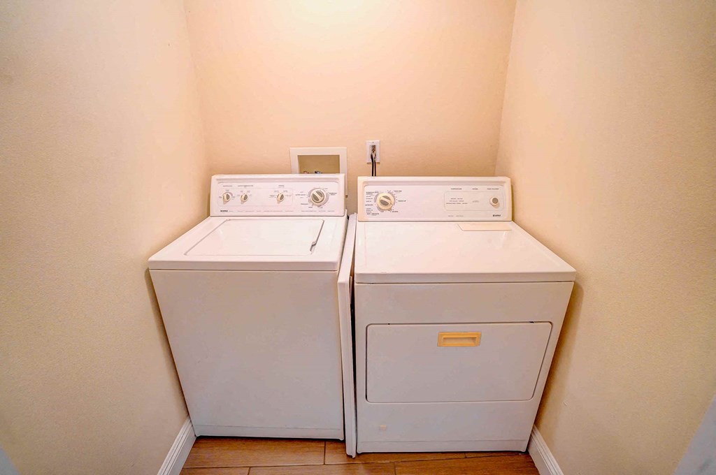 two washes and dryers in the laundry room of a home