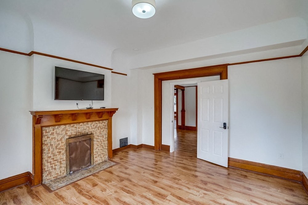 a living room with a fireplace and a door to a hallway