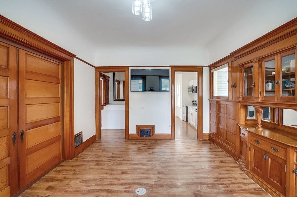 a kitchen with wooden cabinets and a wood floor