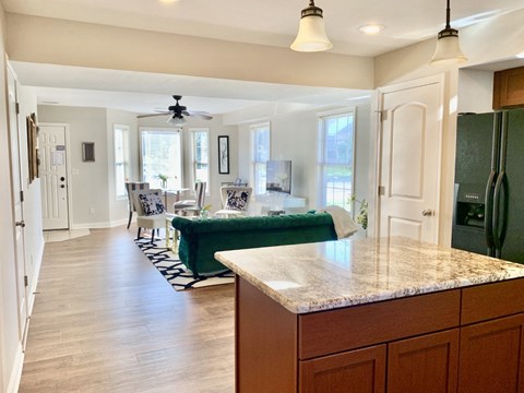 a view from the kitchen into the living room and dining room