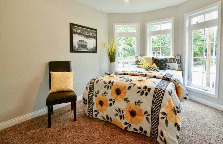 a bedroom with a bed and a chair