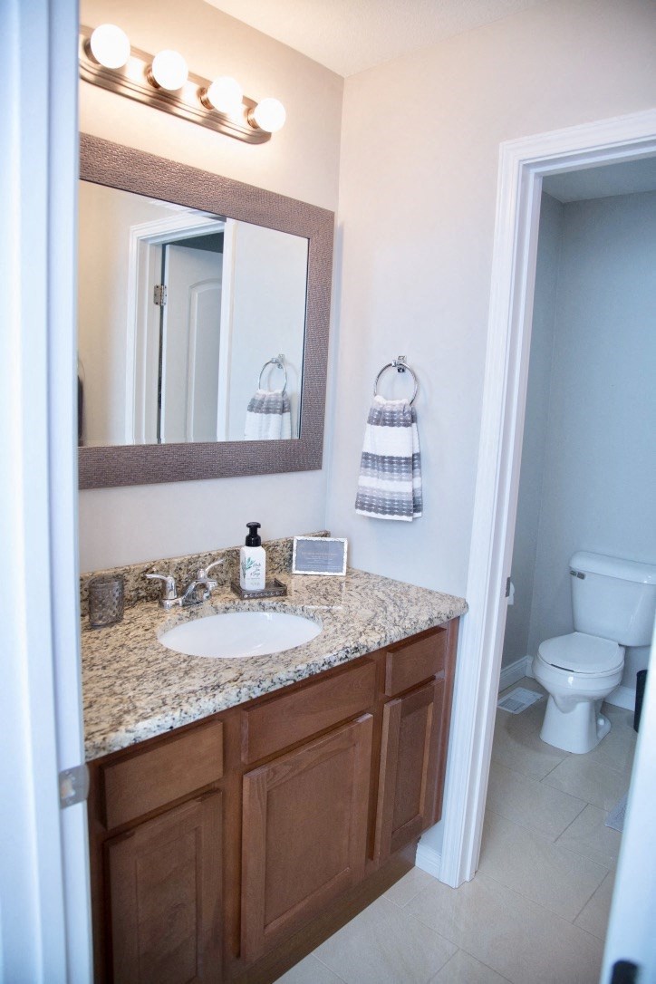 a bathroom with a sink and a mirror and a toilet