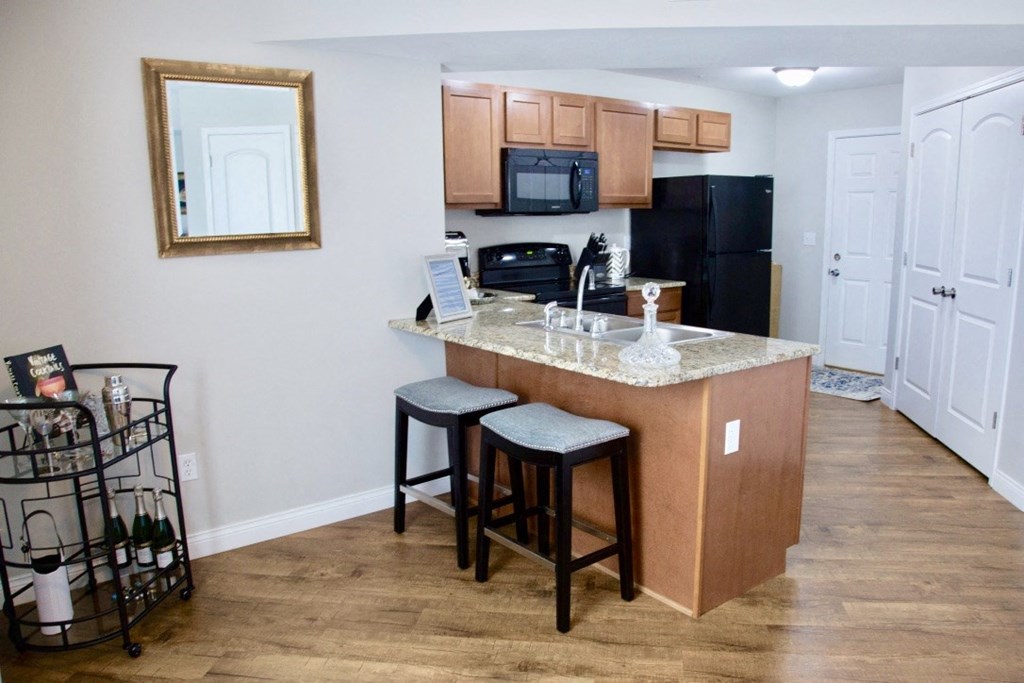 a kitchen with a counter top with two stools