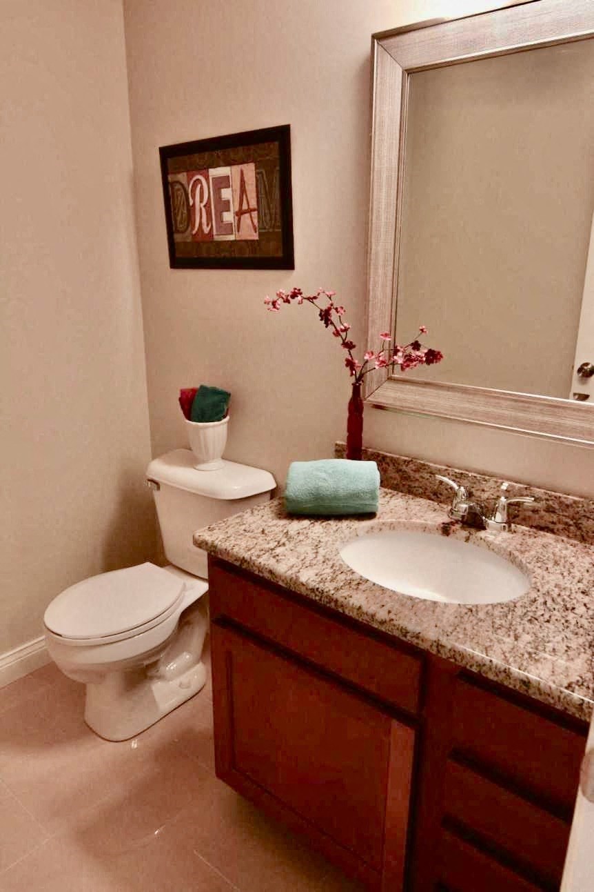 a bathroom with a toilet and a sink and a mirror