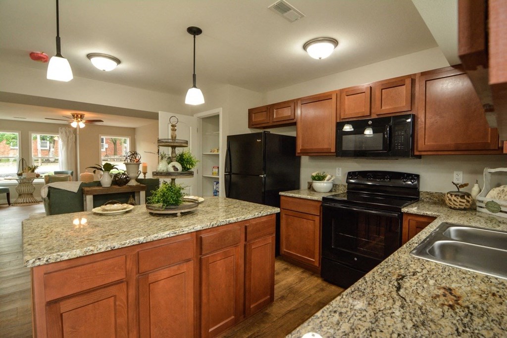 a kitchen with black appliances and granite counter tops