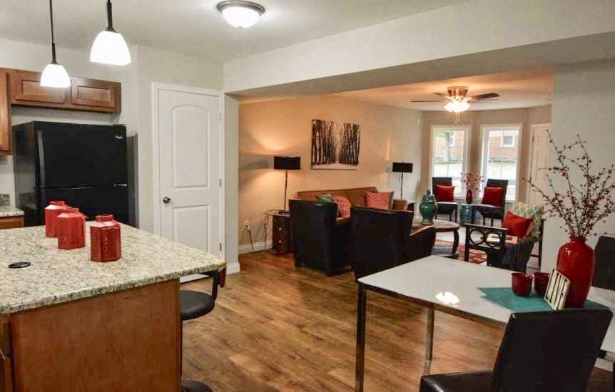 a kitchen and living room with a table and chairs