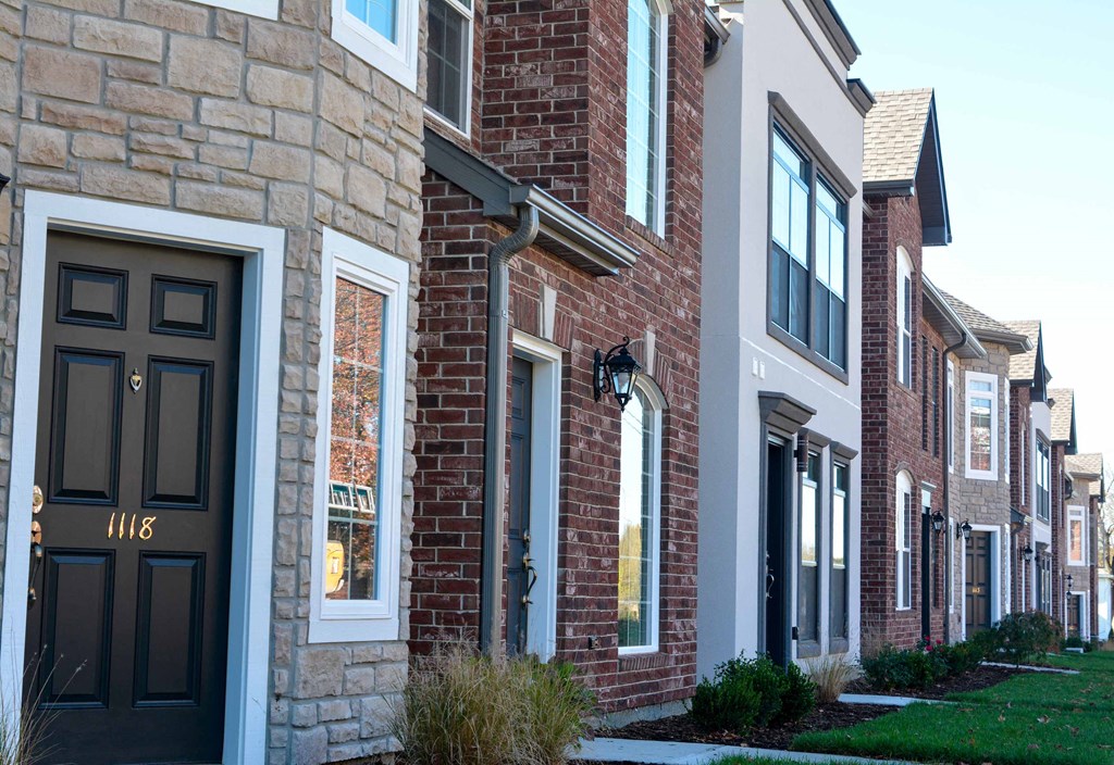 a row of town houses with black doors