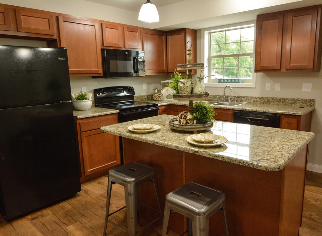 a kitchen with black appliances and granite counter tops