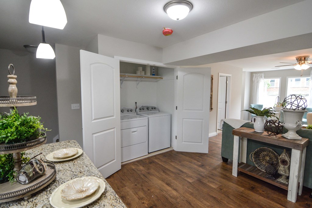 a kitchen with white appliances and a dining room with a table