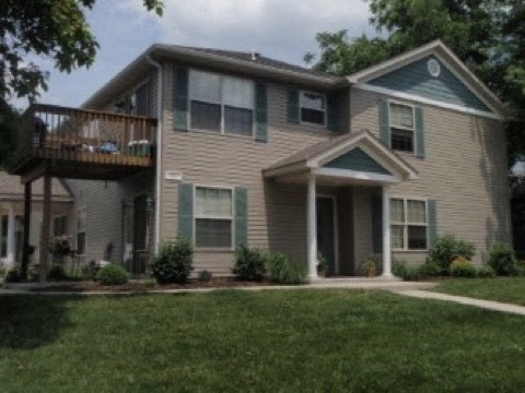 a house with a balcony and a yard