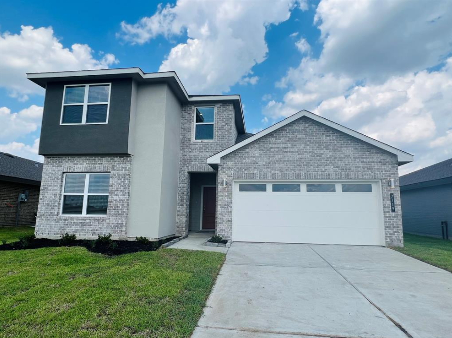 A two-story house with a garage door.