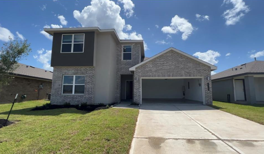 A two-story house with a garage is shown in the image.
