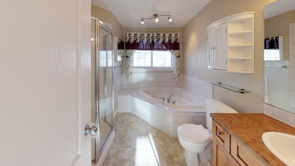 a bathroom with a tub and a toilet and a sink