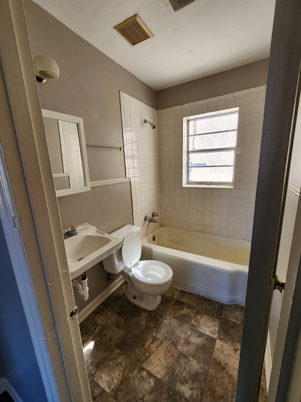 a small bathroom with a toilet and a tub and a sink