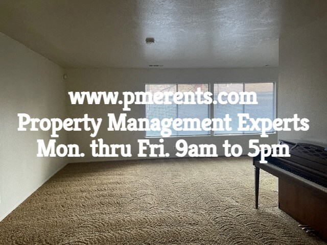 an empty room with a table in it property management experts monday thru fr