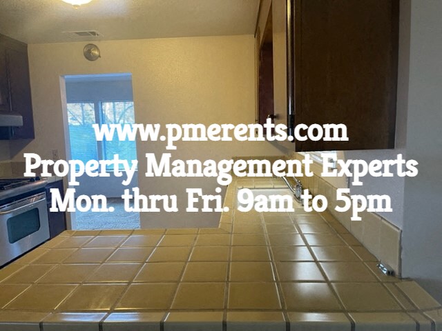 a kitchen with a tile floor and a door