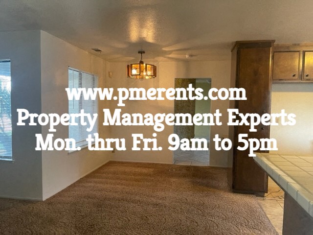a home with a carpet in the living room and a kitchen